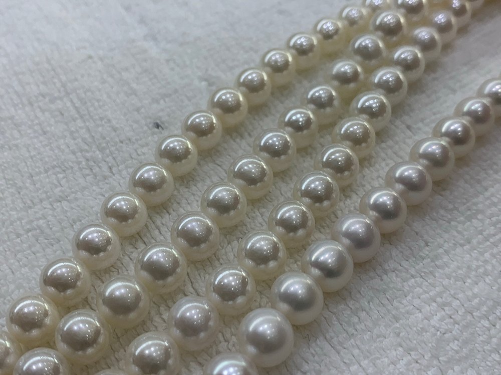 There are three electroplated pearl necklaces on the left and natural pearl necklaces on the right  image